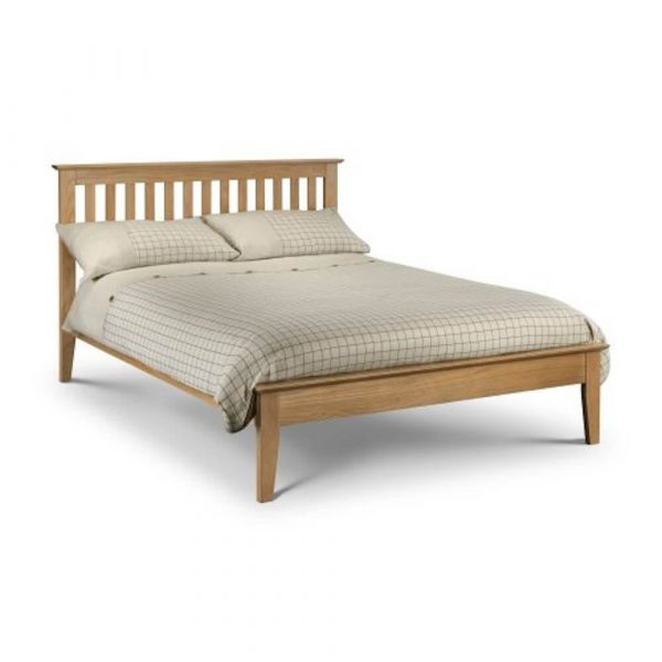 Solid wood double bed frame with mattress and pillows Des Kelly