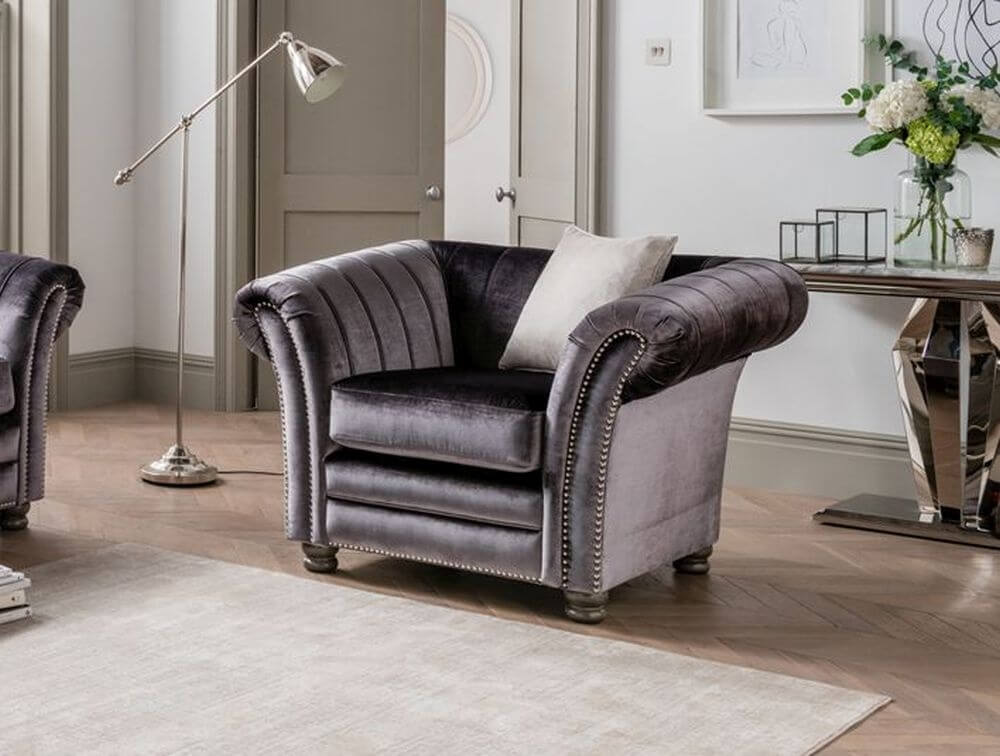 Giselle charcoal grey armchair with a pillow on top