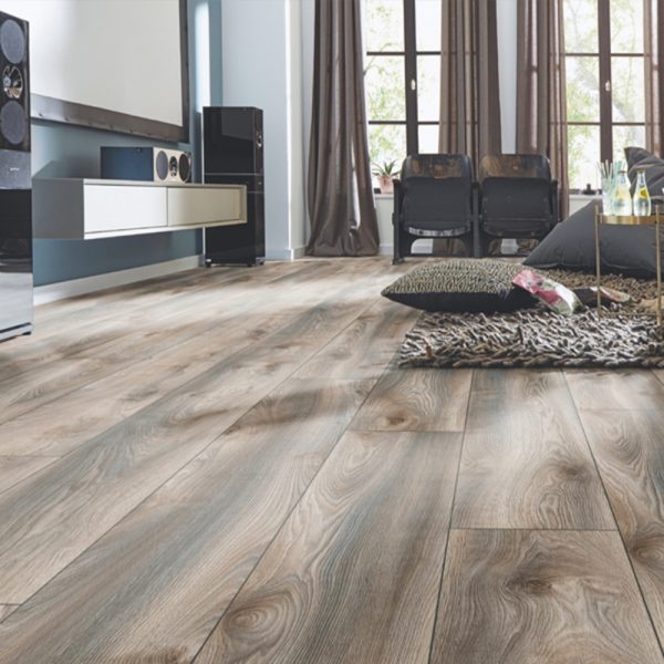 Grey oak wide plank wood flooring with a rug laying on top