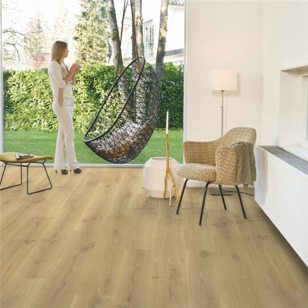 Quickstep Tennessee natural oak wood flooring with a woman in the back
