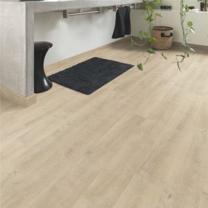 Quickstep oak beige wooden floor with a bathroom rug