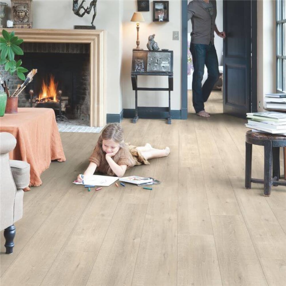 Sawcut quickstep wooden floors and a small girl drawing on top