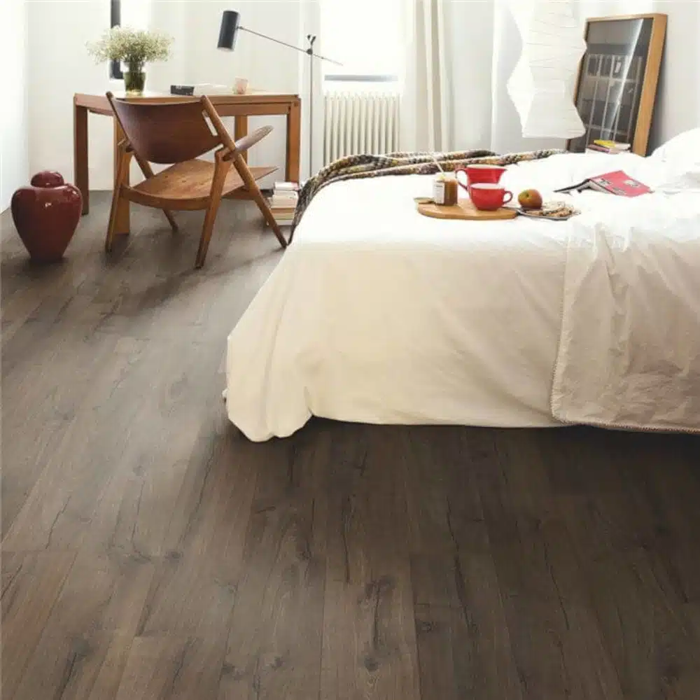 Quickstep impressive brown oak wood floors in a bedroom