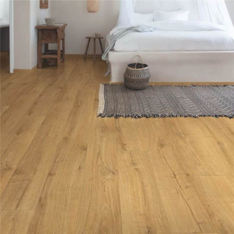 Quickstep wood flooring with a bed frame set on top