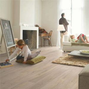 Quickstep wood floors with a rug and sofa on top