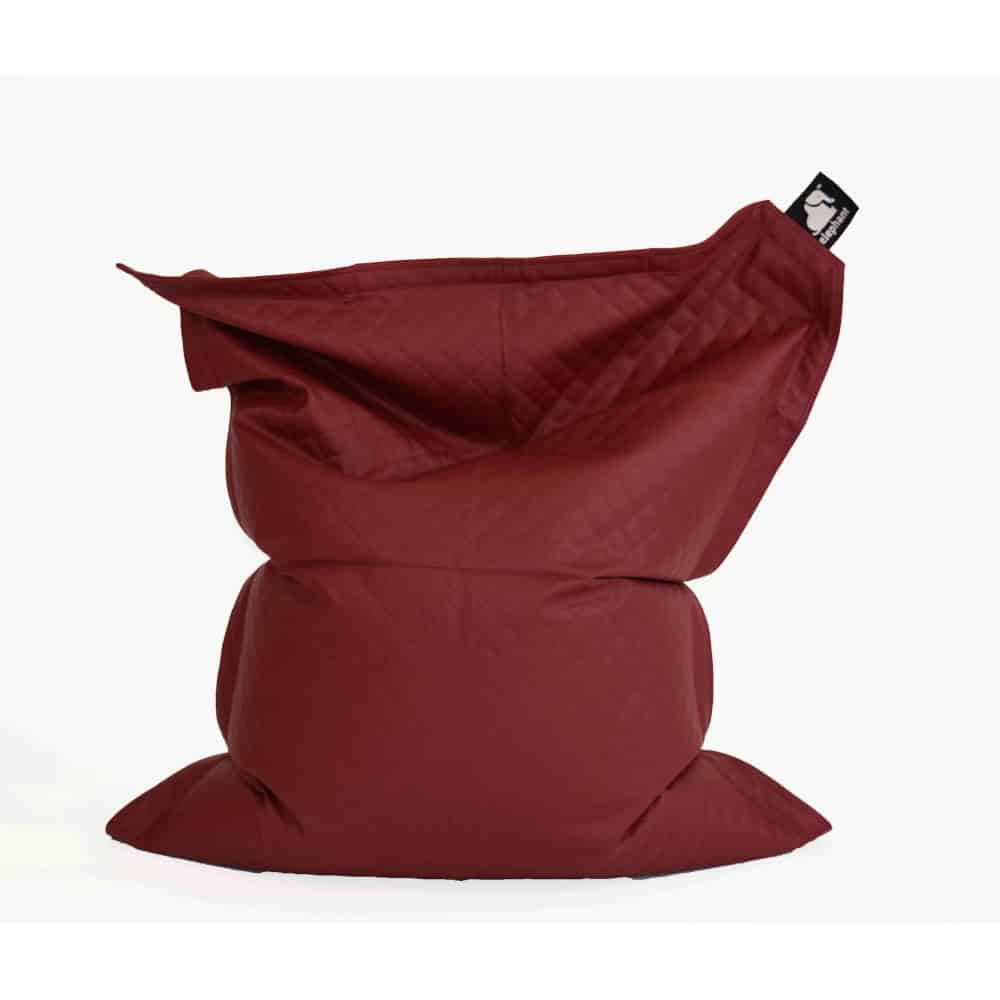 Quilted junior red bean bag standing up on a white background