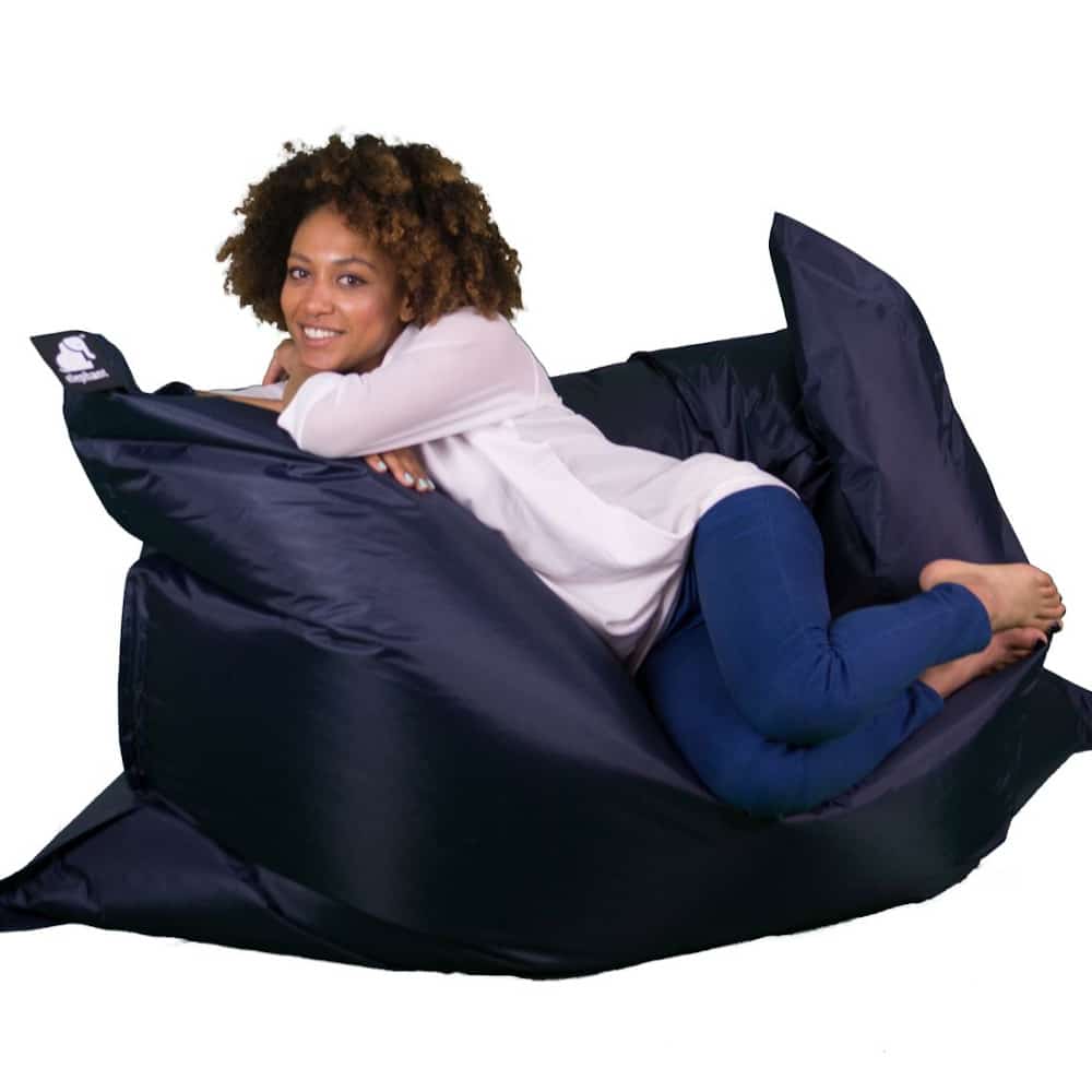 Jumbo midnight blue bean bag with a woman on top smiling