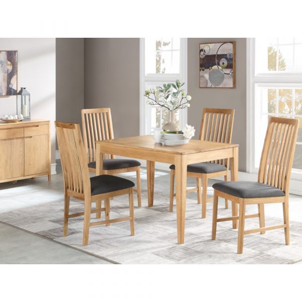 Dunmore dining set with cushioned chairs on a stylish rug